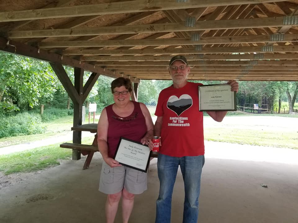 Judy Petersen and Sam Avery holding Judy's KFTC awards for spending time lobbying in Frankfort.