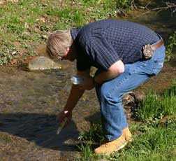 Rick Handshoe taking a water sample